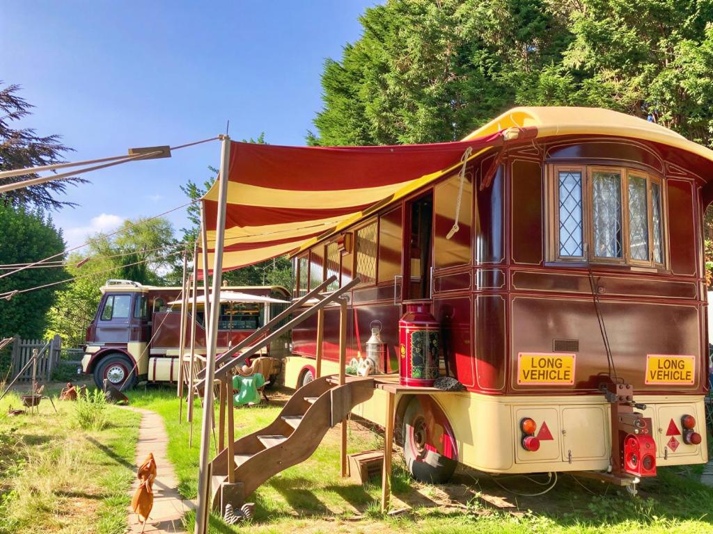 an old bus with a slide in the yard at Molly the Showman's Wagon in Hailsham