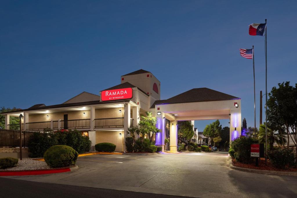 a mobil gas station at night with an american flag at Ramada by Wyndham San Antonio Near SeaWorld - Lackland AFB in San Antonio
