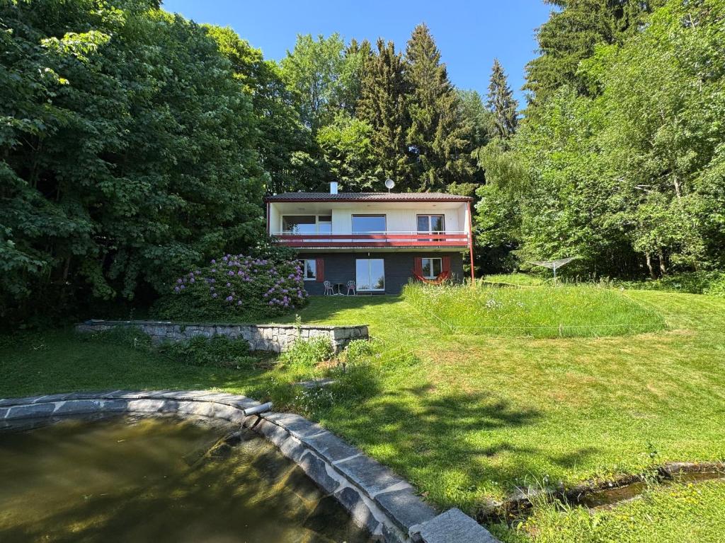 a house with a pond in front of it at Alpenblick-Hotzenwald in Rickenbach