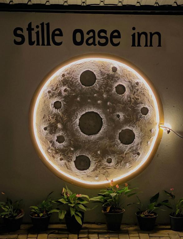 a sign that reads silk oase im hanging on a wall at Stille Oase Inn in Matara