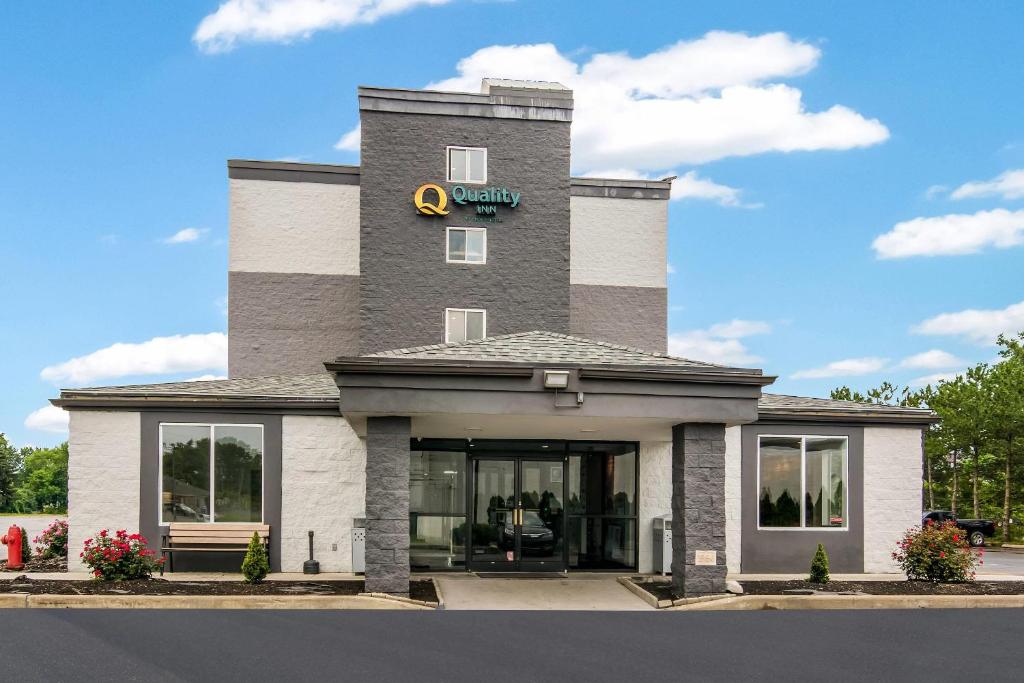 a hotel with a sign on the side of a building at Quality Inn Rochester West in Rochester