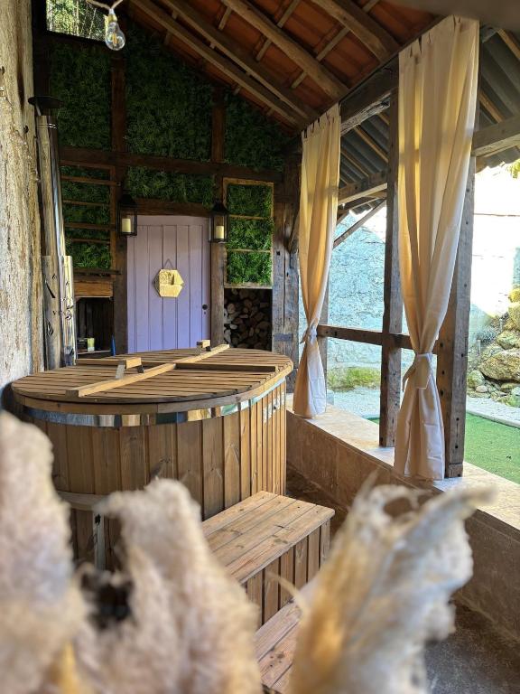 a large wooden sauna in a building with curtains at Vénusté, Suite romantique in Périgueux