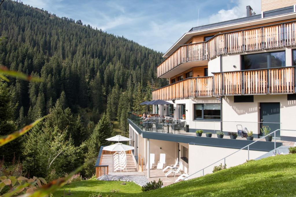 a hotel with a view of a mountain at Hotel Zirbenhof in Hochfugen