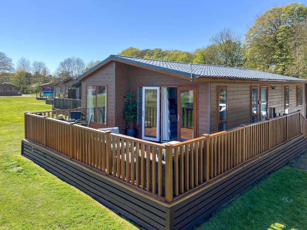 a large wooden house with a large deck at The Valerie Jean in Bridlington