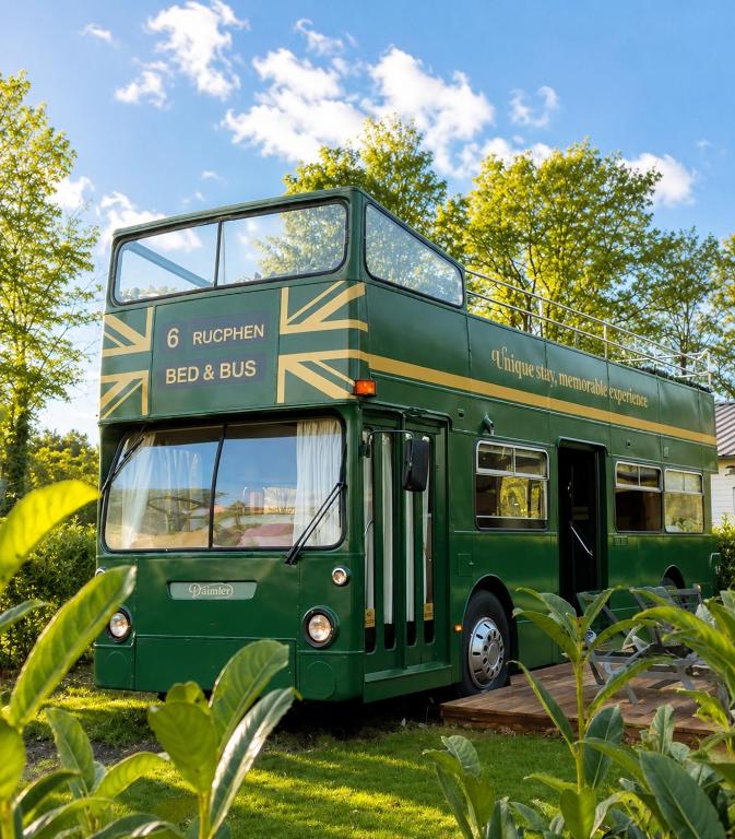 a green double decker bus parked in the grass at Bed&Bus met dakterras in Rucphen