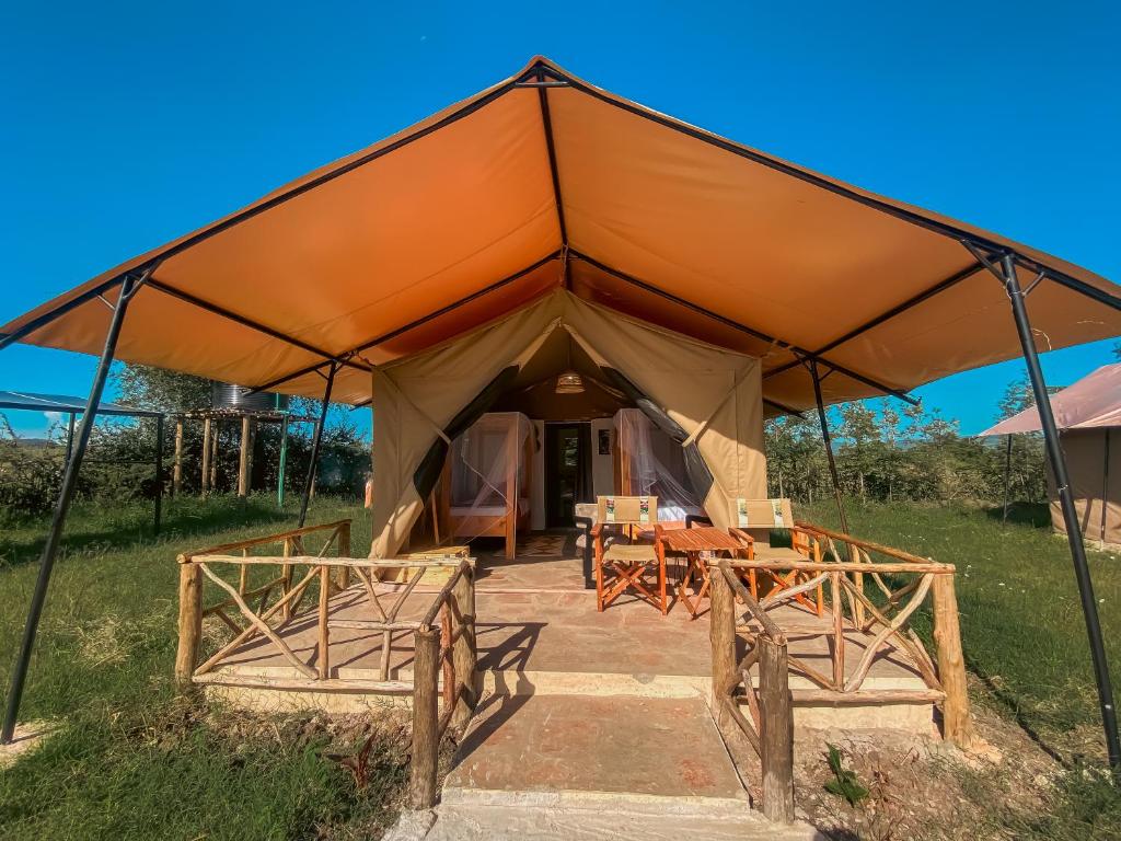 a large tent with chairs and tables in it at Emaamara camp in Narok