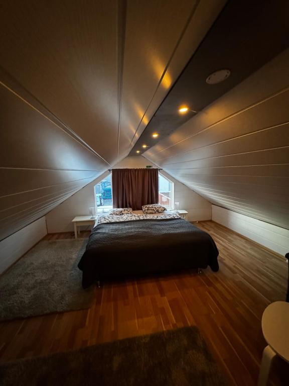 a bedroom with a bed in a room with a window at Bjarmaland in Vestmannaeyjar