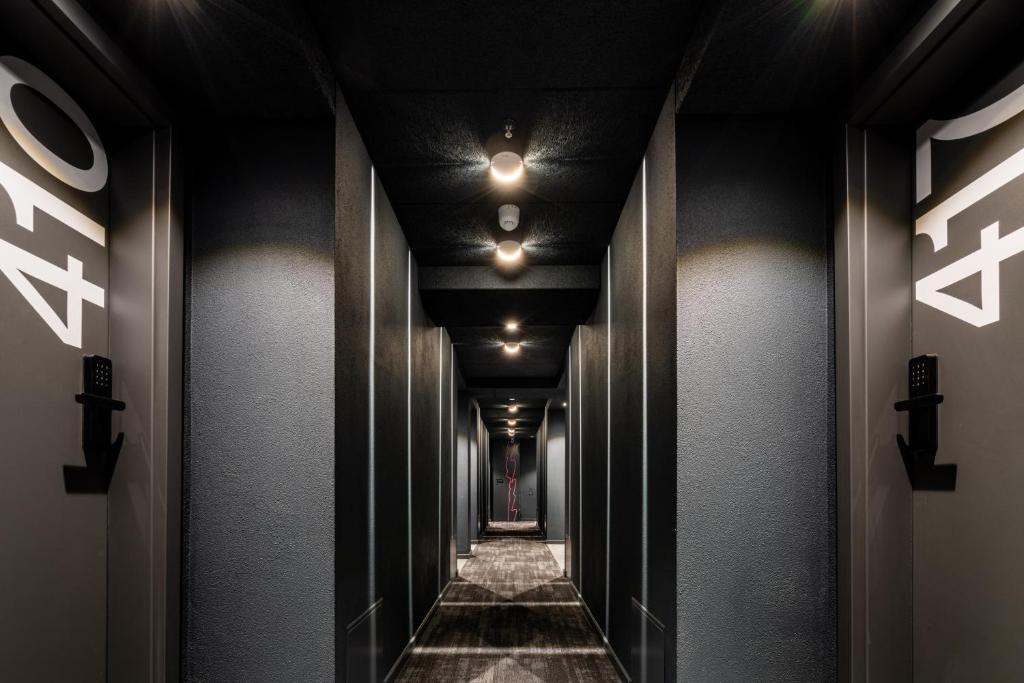 a corridor of a building with black walls and lights at Savoy Hotel in Frankfurt