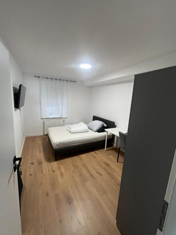 a bedroom with a bed and a desk in it at Ethical Choice Residence in Kaiserslautern
