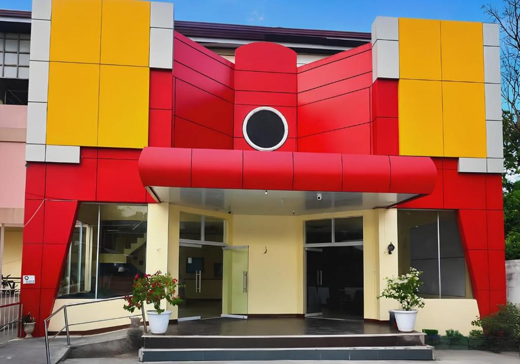 a building with a large red dog on the front at Kyleville Resort by Hiverooms in Dalaguete
