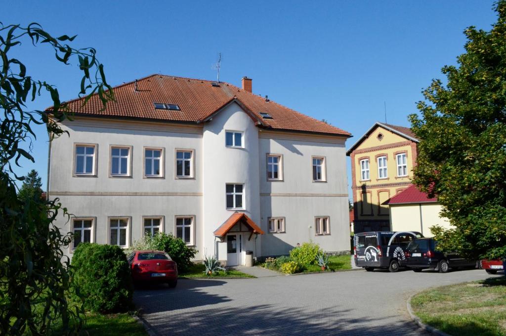 a large white house with a red roof at Penzion Poodří in Suchdol nad Odrou