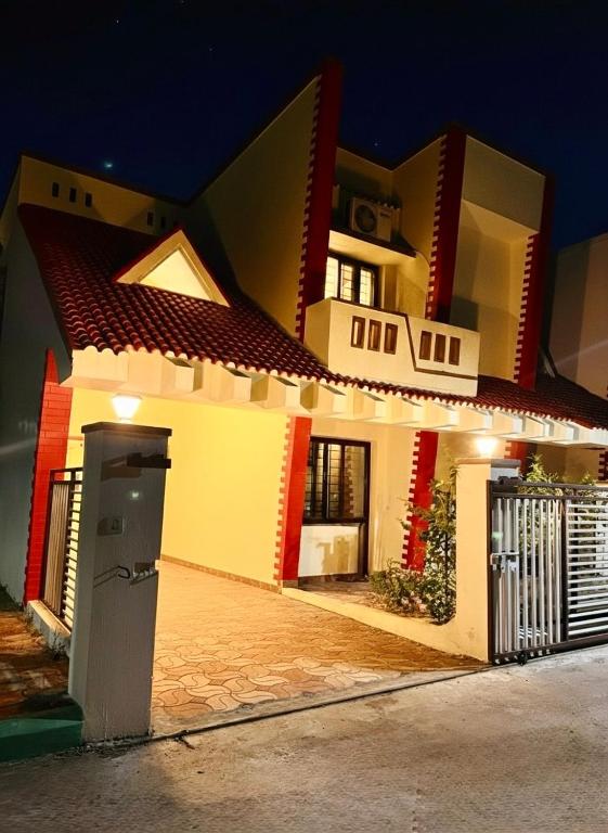 a large white house with a driveway in front of it at Serenity Villa in Rushikonda
