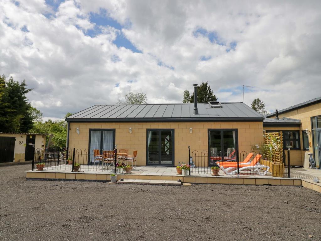 a home with a patio and a house at The Barn in Redditch