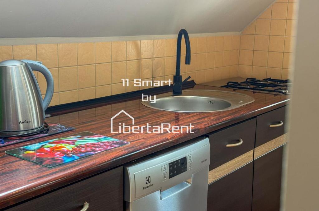 a kitchen with a sink and a counter top at 11 smart by LibertaRent in Wałbrzych