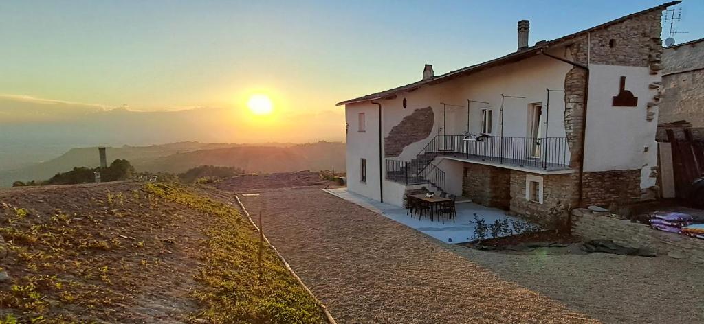a house on a hill with the sunset in the background at Bella vista 2 in Castellino Tanaro
