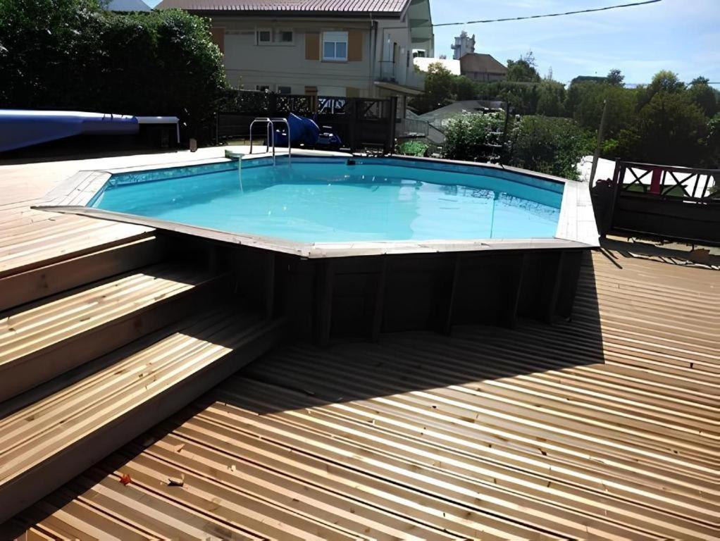 a swimming pool on a deck with a wooden floor at Villa Cathy Studio Terrasse Léane in Aix-les-Bains