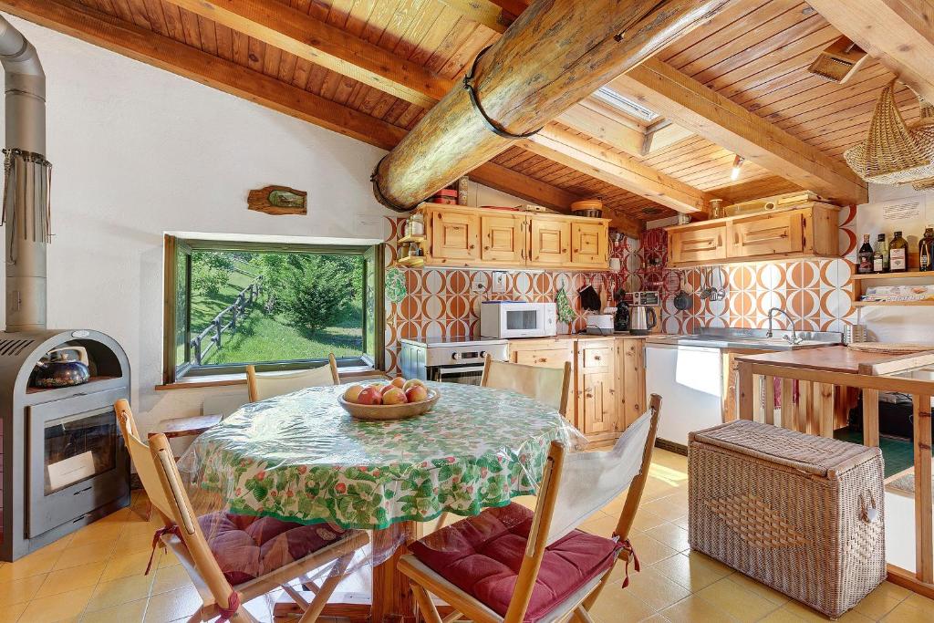 a kitchen with a table with a bowl of fruit on it at La Tana con l'Ermellino in Morgex