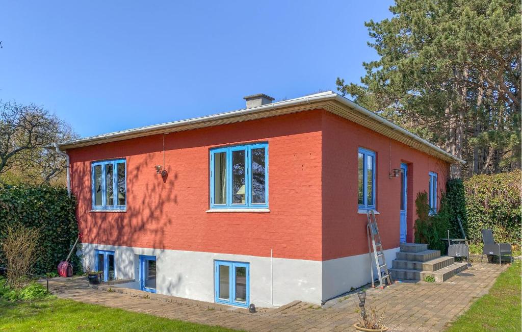 a red and white house with at 2 Bedroom Nice Home In Hundested in Hundested