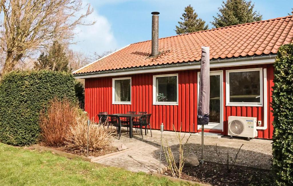 a red house with a table in front of it at Beautiful Home In Holbæk With Wifi in Holbæk