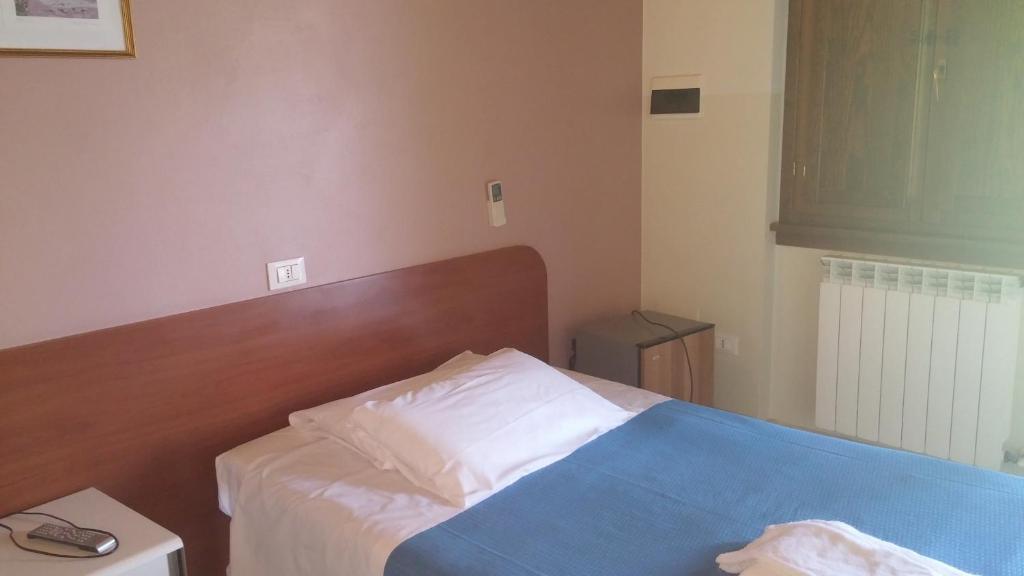 Postel nebo postele na pokoji v ubytování Albergo Dell'angelo
