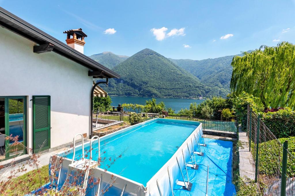 a swimming pool with a view of a mountain at Villa Porlezza Lake view in Cima