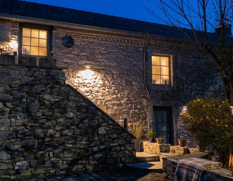 a stone house with a stone wall and stairs at Pierres & prée Cocon de Charme et sa terrasse étoilée in Mettet