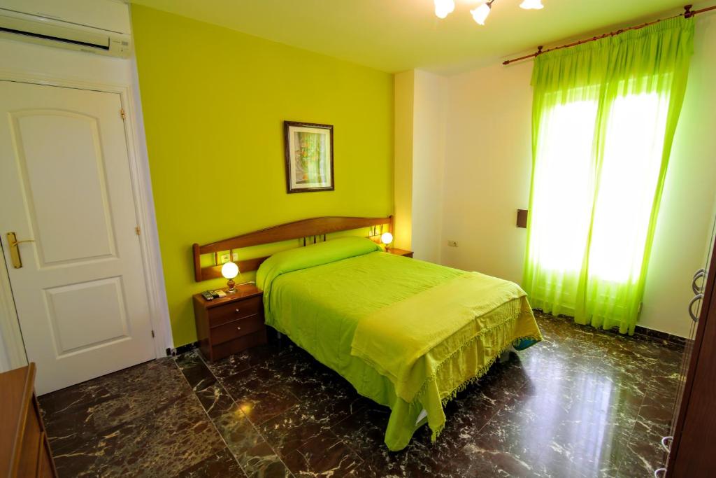 Posteľ alebo postele v izbe v ubytovaní Apartamentos Turísticos La Fonda
