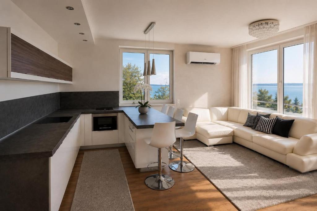 a kitchen and living room with a couch and a table at Marcelo Deluxe Apartment in Tihany