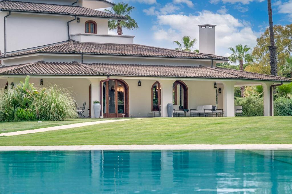 a house with a swimming pool in front of it at Villa Lena Puglia in Oria