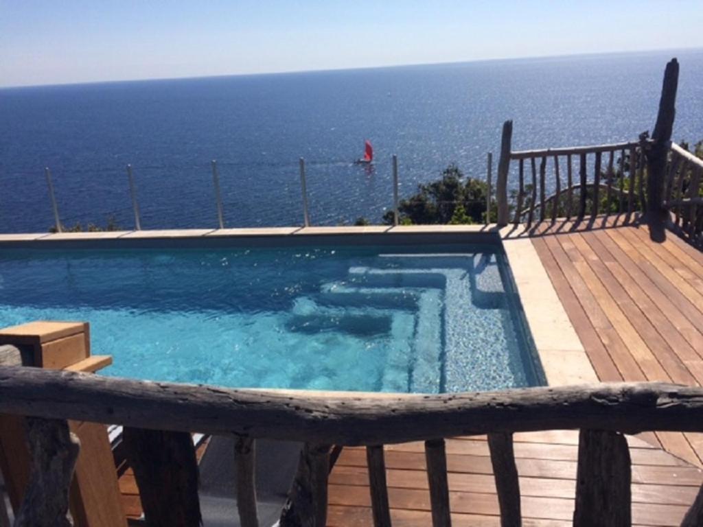 a swimming pool with a view of the ocean at ALICIA in Zonza