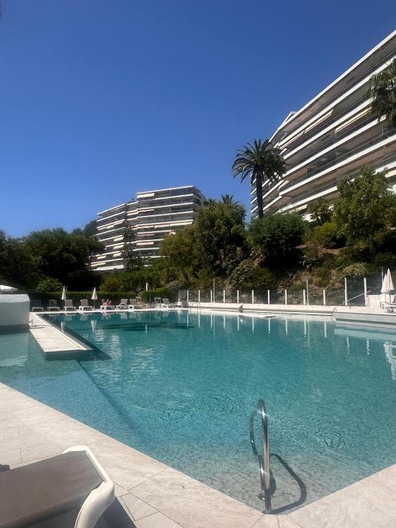 a large swimming pool in front of a building at CANNES La Mirandole in Golfe-Juan