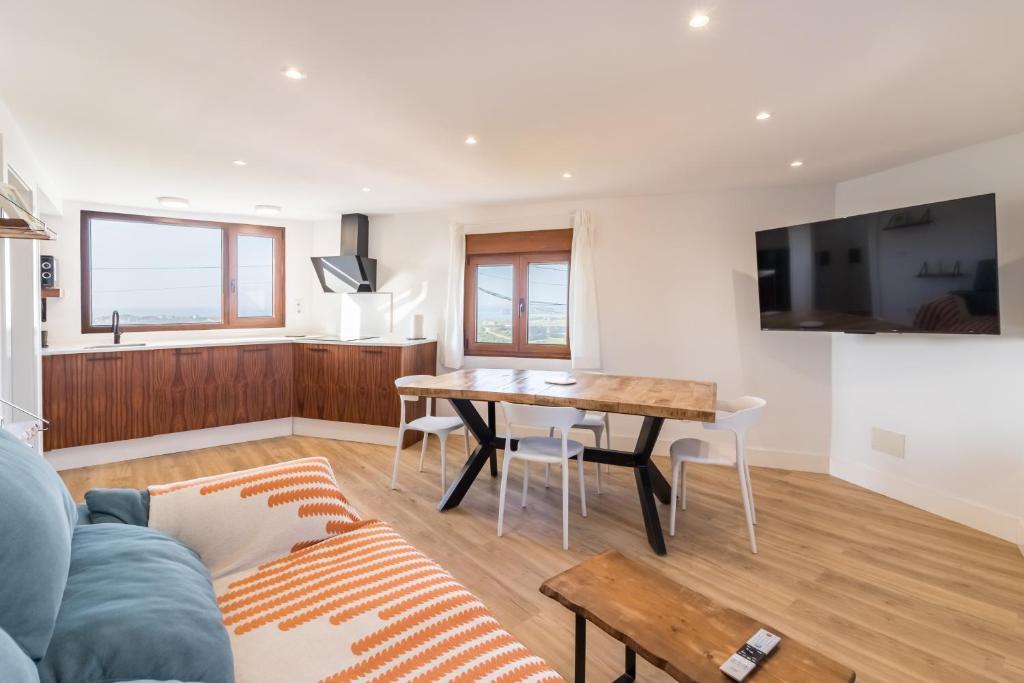 a living room with a table and a couch at El Rincón de Denver 2 in Suances