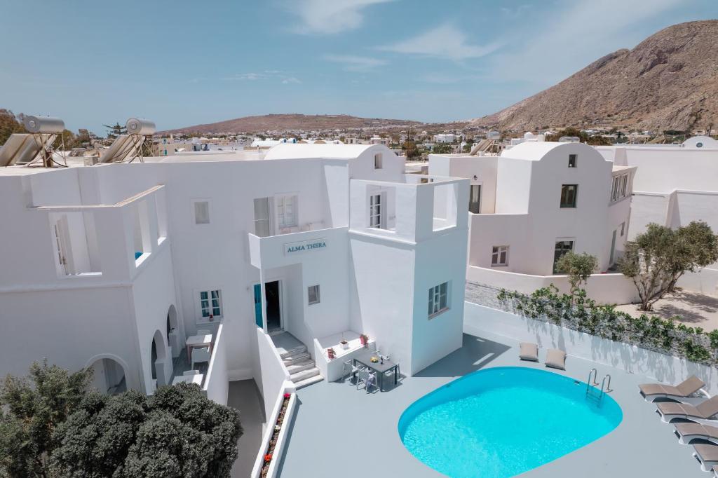 an aerial view of a villa with a swimming pool at ALMA THERA Boutique Hotel in Perissa