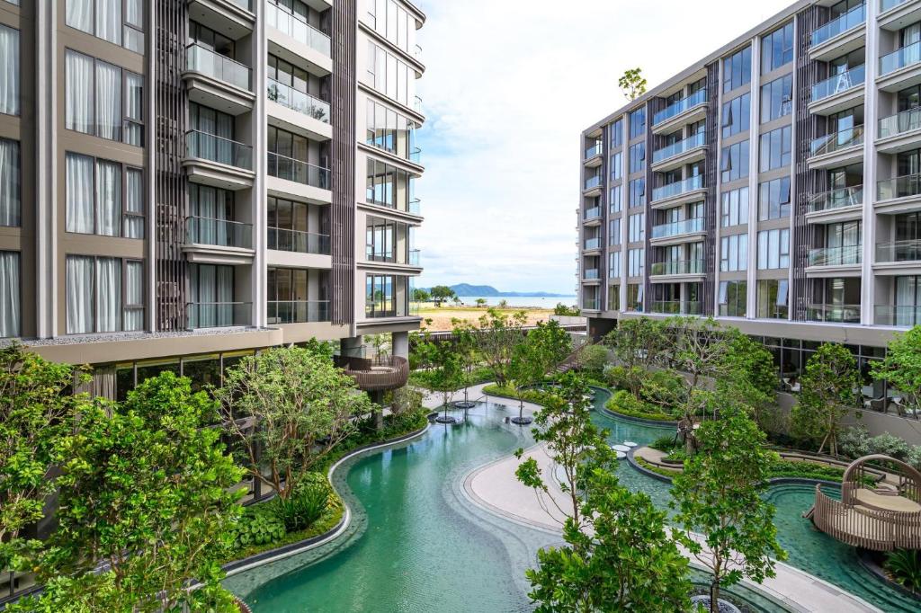 an aerial view of a river between two buildings at Beachfront 1BDR Condo (PE24) in Na Jomtien