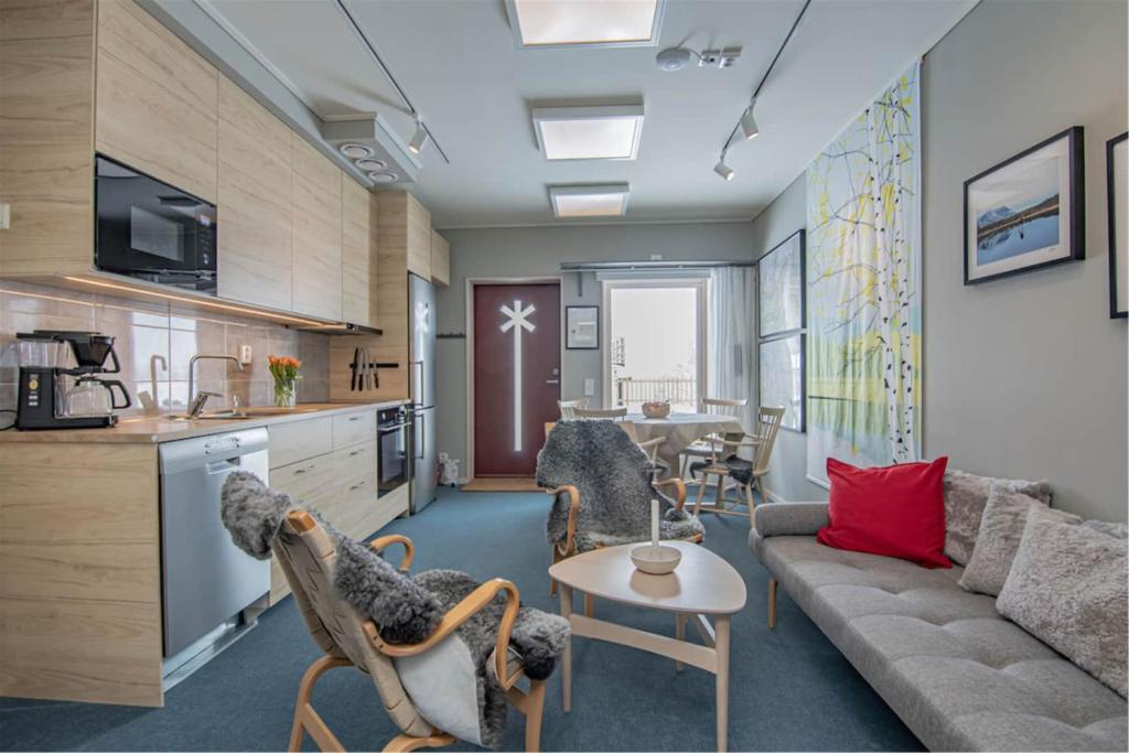 a living room with a couch and a table at Hemavan Mountain Lodge Jofjället in Hemavan