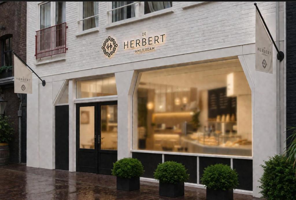 a store front of a herbert restaurant in the rain at De Herbert Amsterdam - Formerly France Hotel in Amsterdam