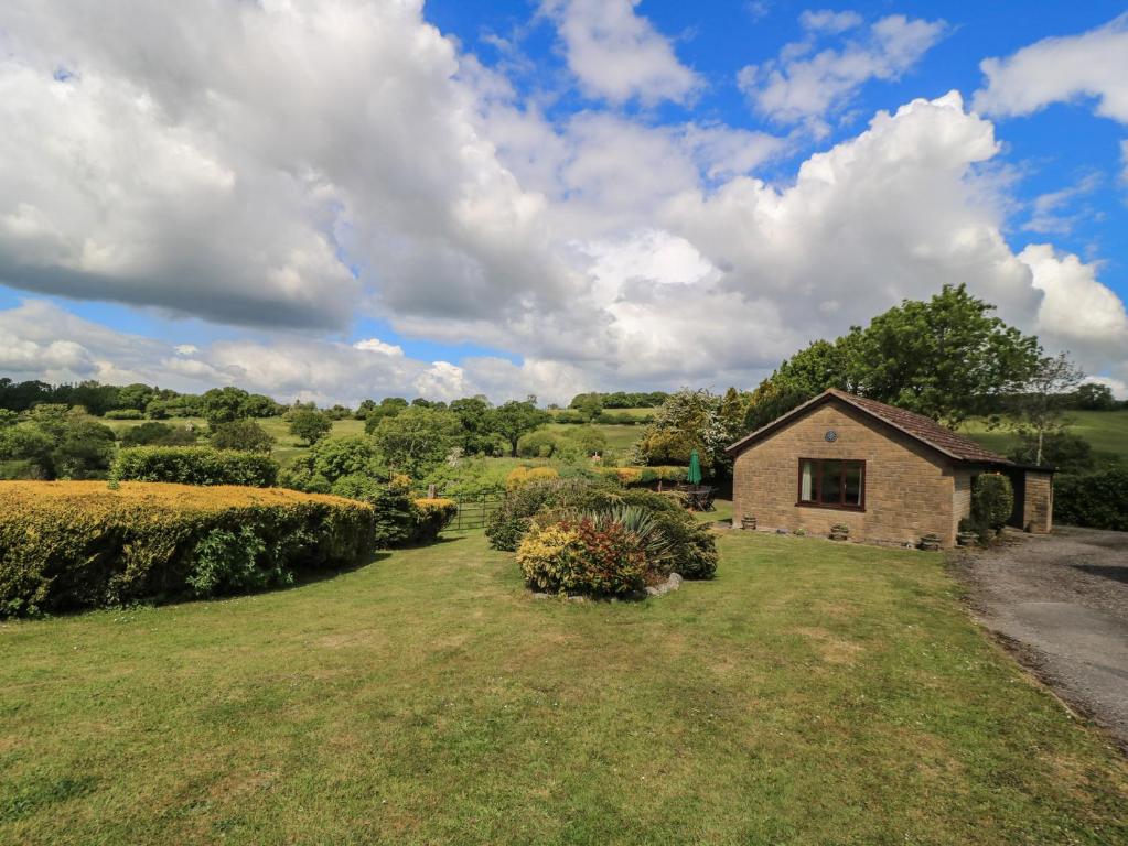 a stone house in the middle of a field at Ryecross Farm Cottage in Melbury Abbas