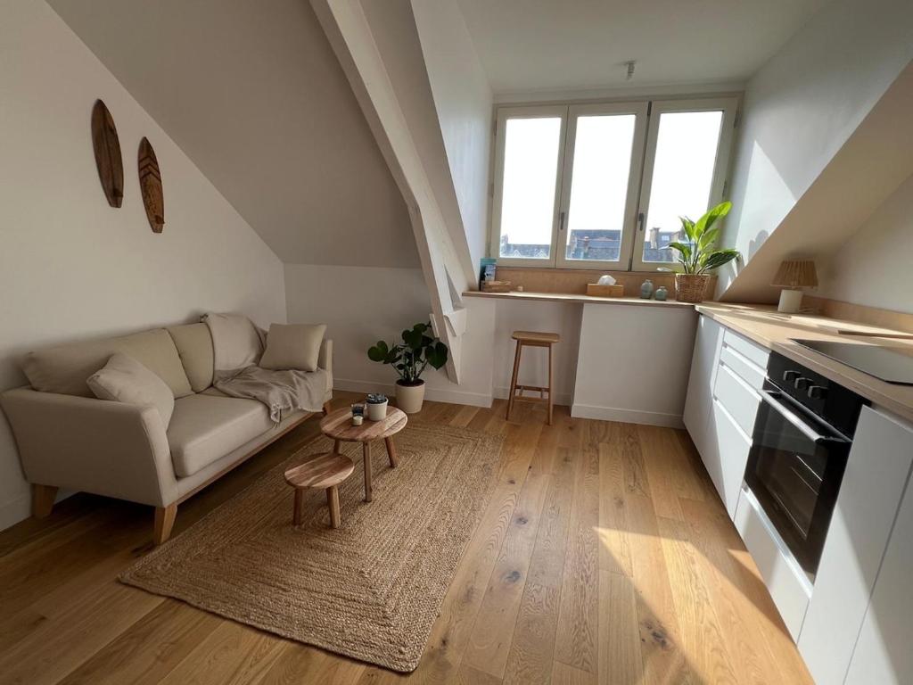 a living room with a couch and a table at Cozy studio in Cancale in Cancale