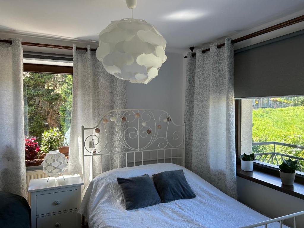 a bedroom with a bed and a large window at Kwatery u Marysi in Szczyrk