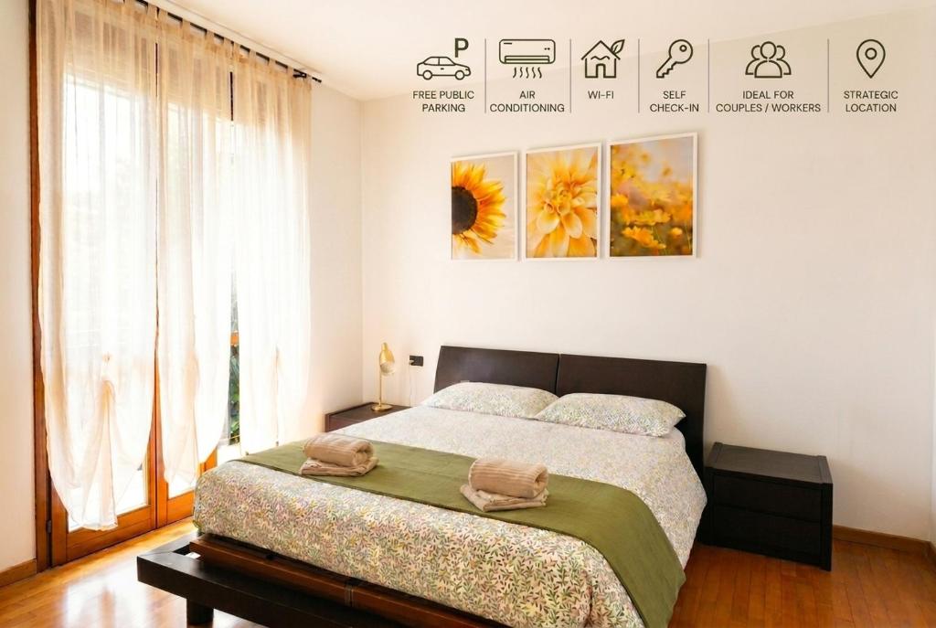 a bedroom with a bed and a large window at Apartment near Lake Como -300m to station -AC in Valmadrera