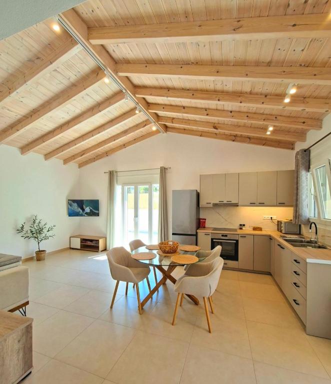 a kitchen and dining room with a table and chairs at Villa Eleni Apartment no3 in Agios Gordios