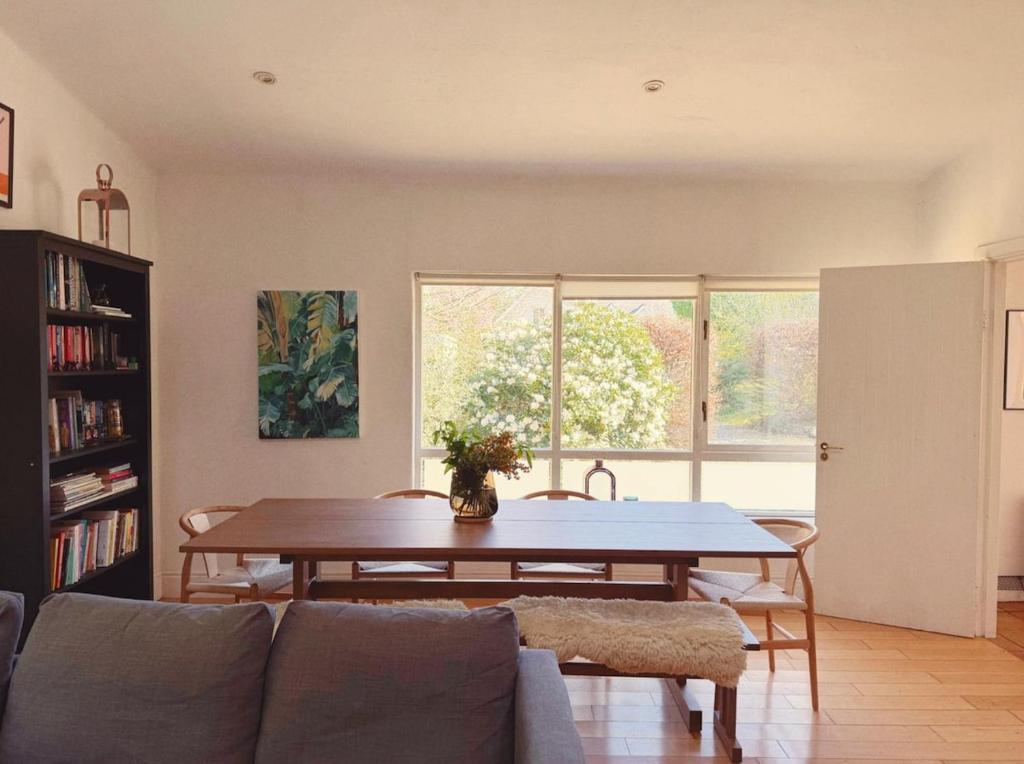 a living room with a table and a couch at 2 bed cottage, in the Wicklow Mountains in Tinahely