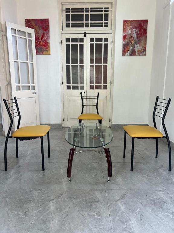 two chairs and a glass table in a room at Floreen villa in Moratuwa