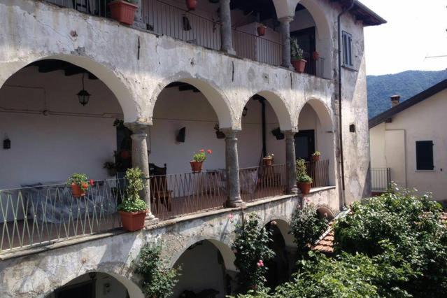a building with arches and potted plants on it at Casa Clerici - Cà del merican in Nonio