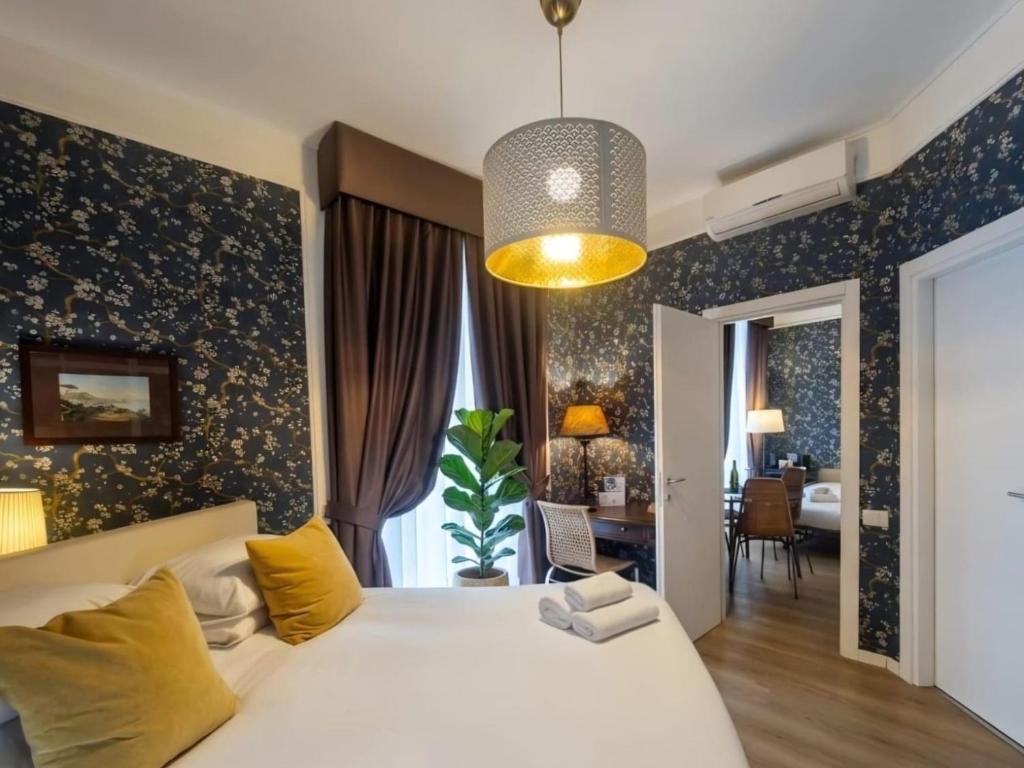 a bedroom with a large white bed with yellow pillows at Residenza Echia in Naples