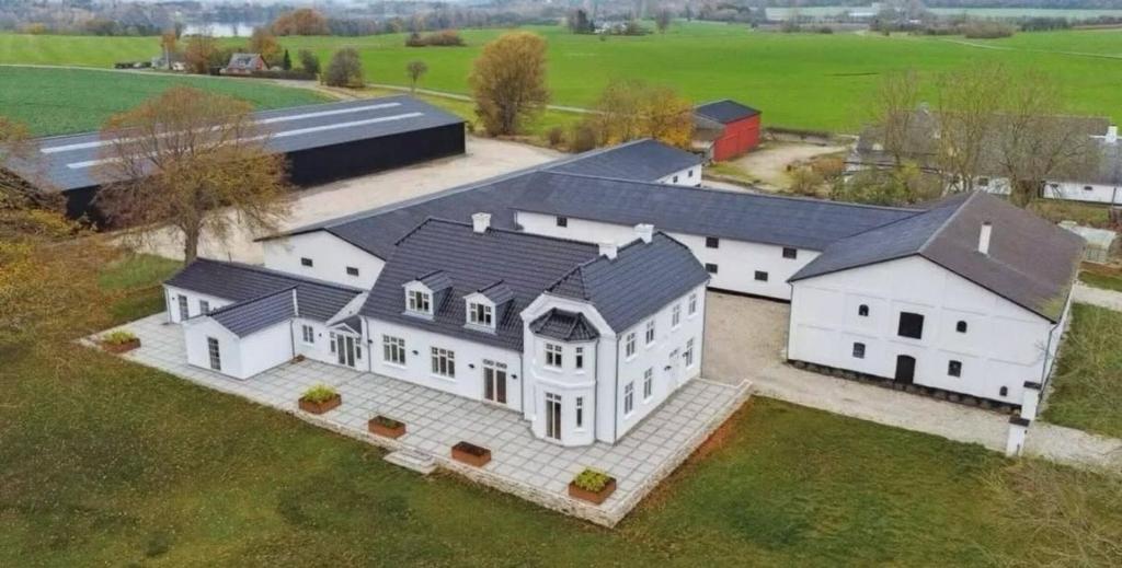 an aerial view of a large white house at Estate in calm nature in Sorø