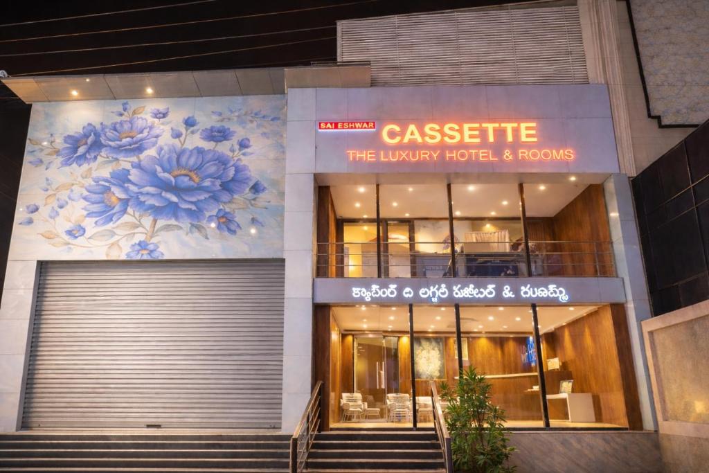 a building with a sign that reads casete the luxury hotel and rooms at Cassette Inn in Zahirābād