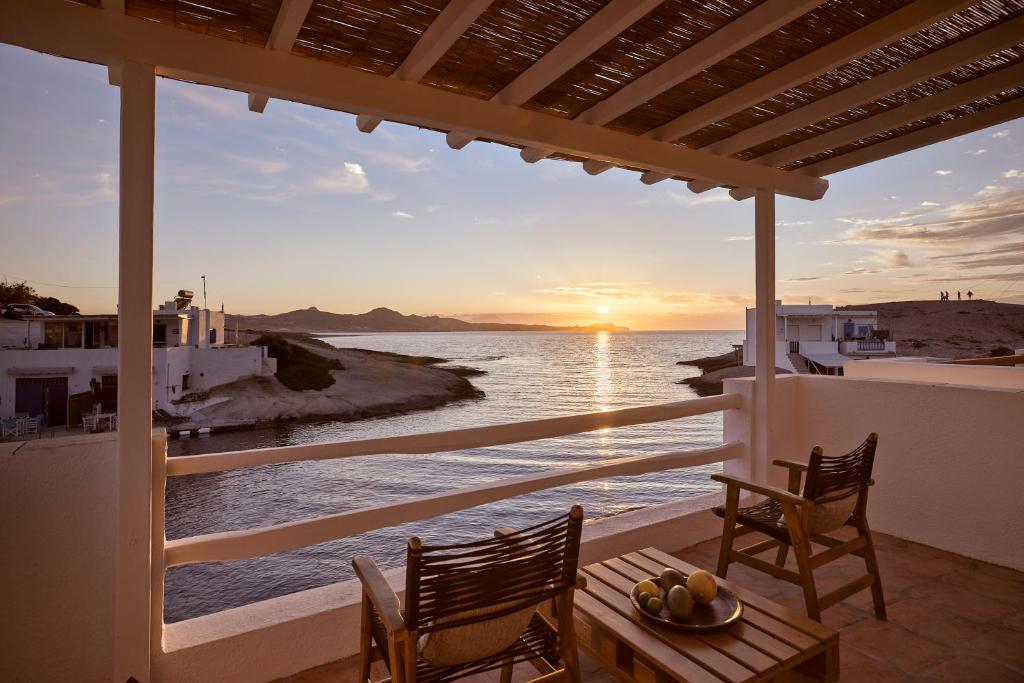 a view of the ocean from the balcony of a house at Infinito Boathouse Milos in Agia Irini Milos