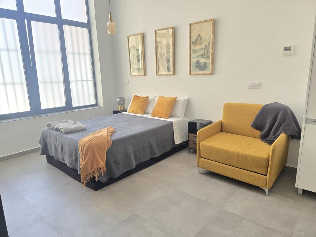a bedroom with a bed and a chair at Jardín Viveros-Turia in Valencia