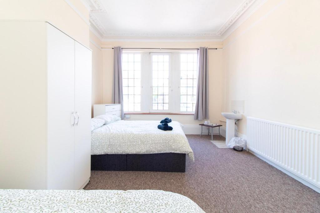a bedroom with two beds and a window at Room 2 - Brookvale Guest House in Southampton